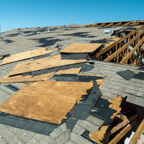 Damaged roof with missing shingles in Colorado